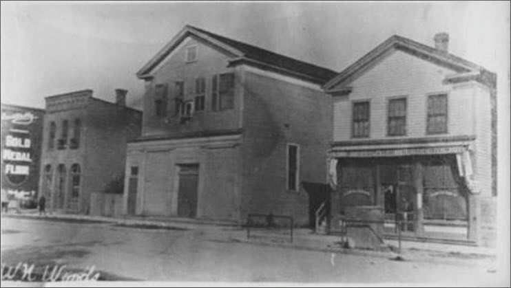 The first building (center), circa 1837, Maumee, Ohio. Purchased from the Sons of Temperance in 1854.